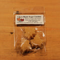 Clear package of pure maple sugar candies with a label on a wooden surface