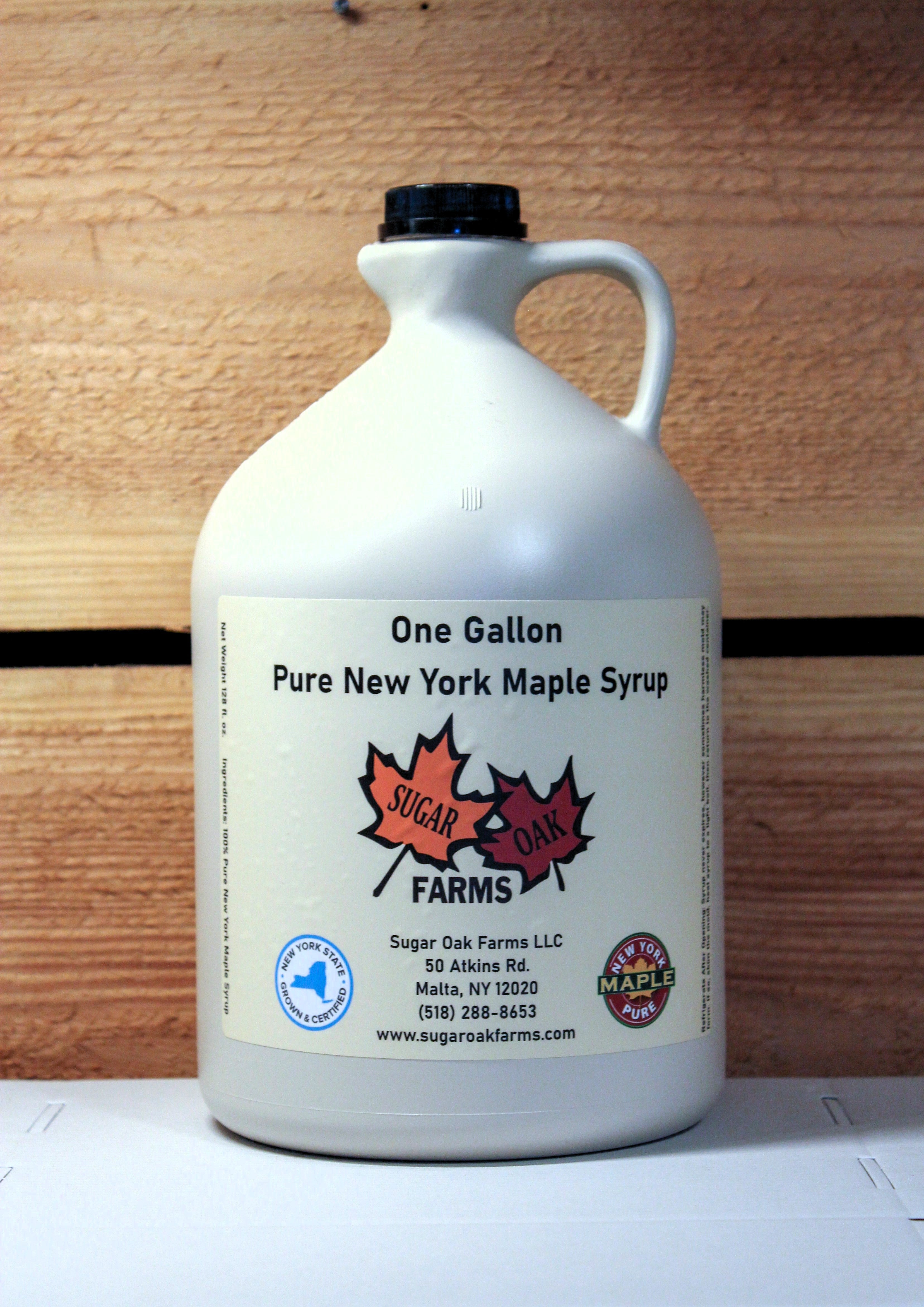 A plastic gallon jug of amber syrup.
