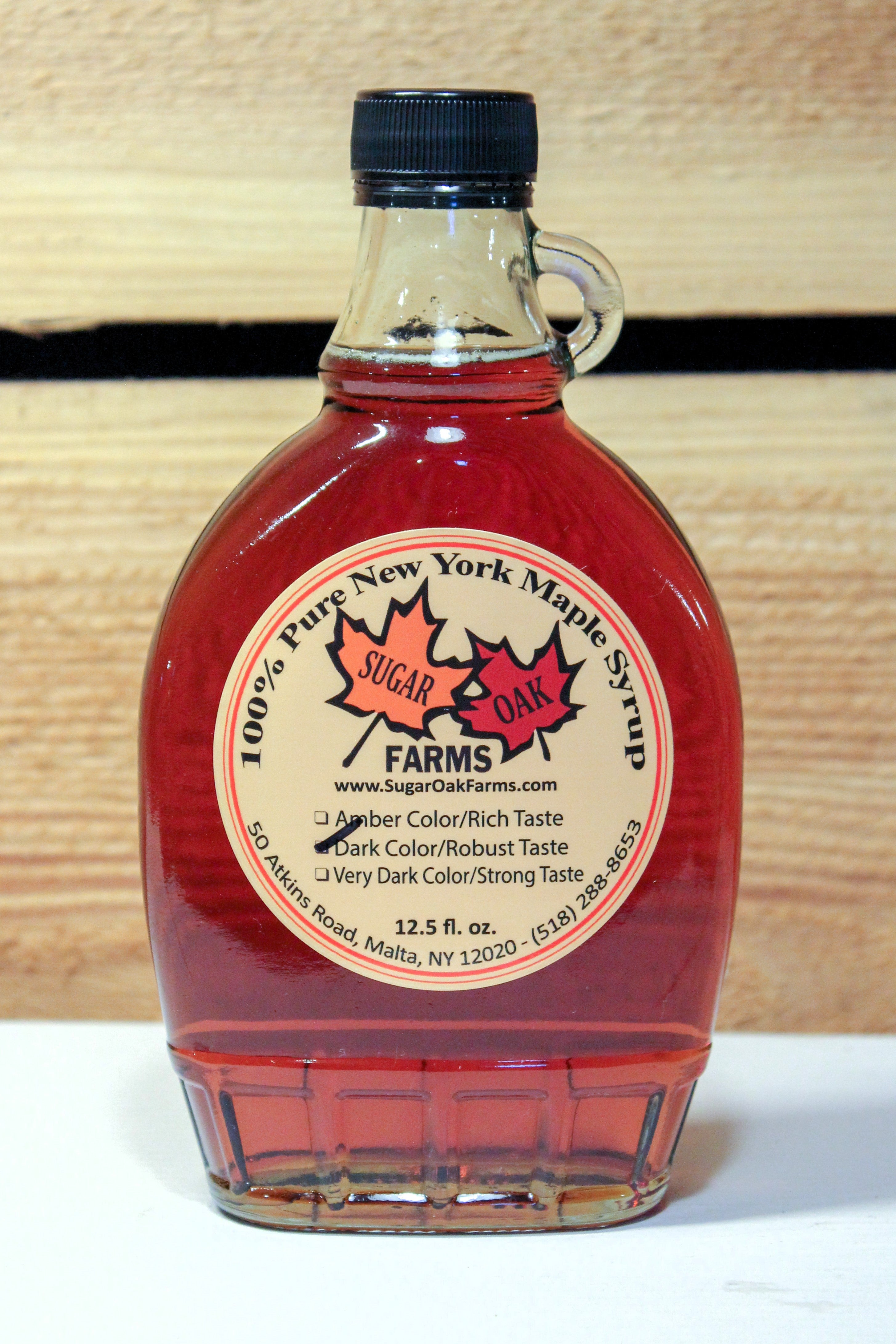 A 12.52 fl. oz. glass bottle of dark syrup.