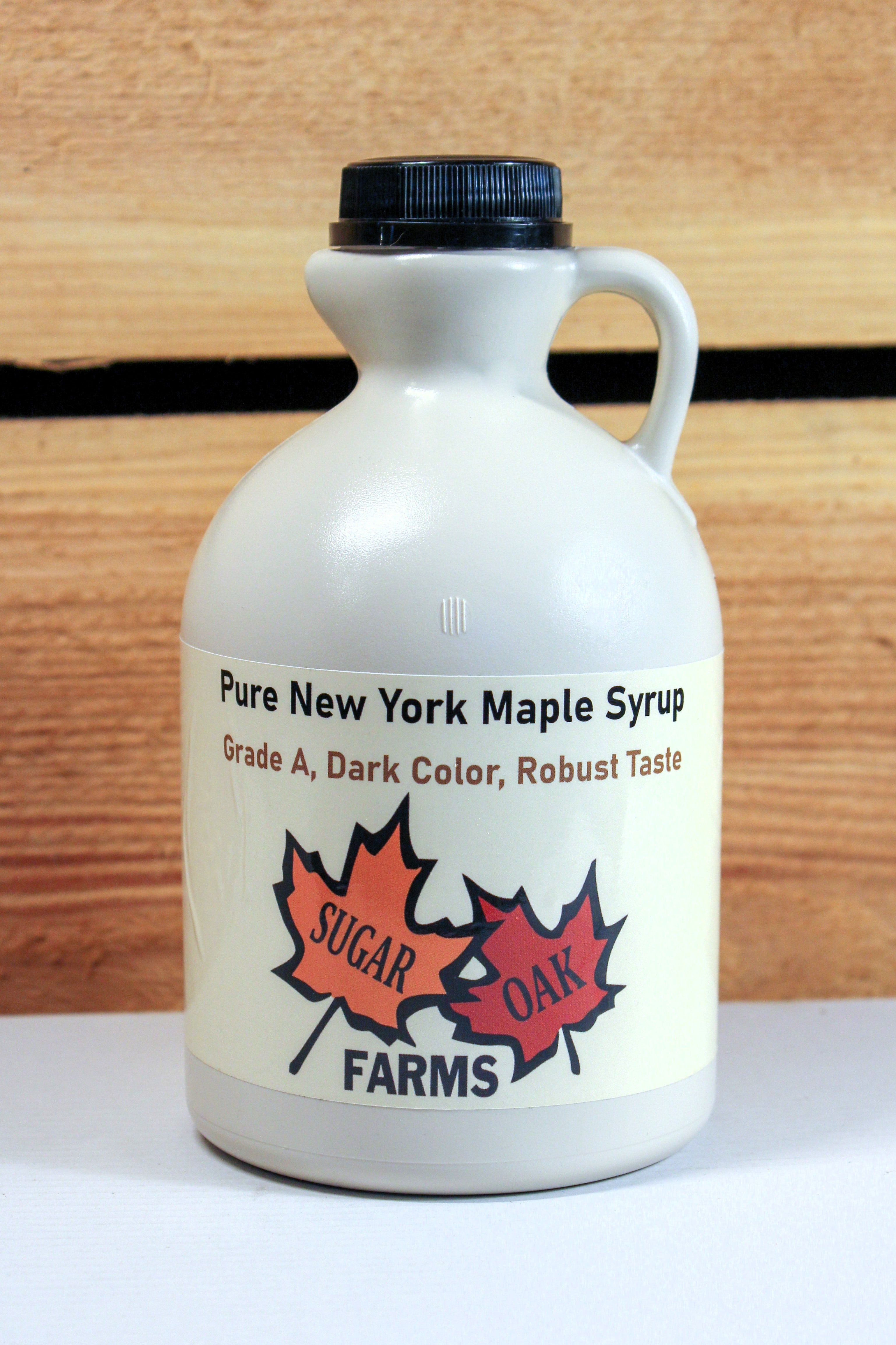 A plastic quart jug of dark syrup.