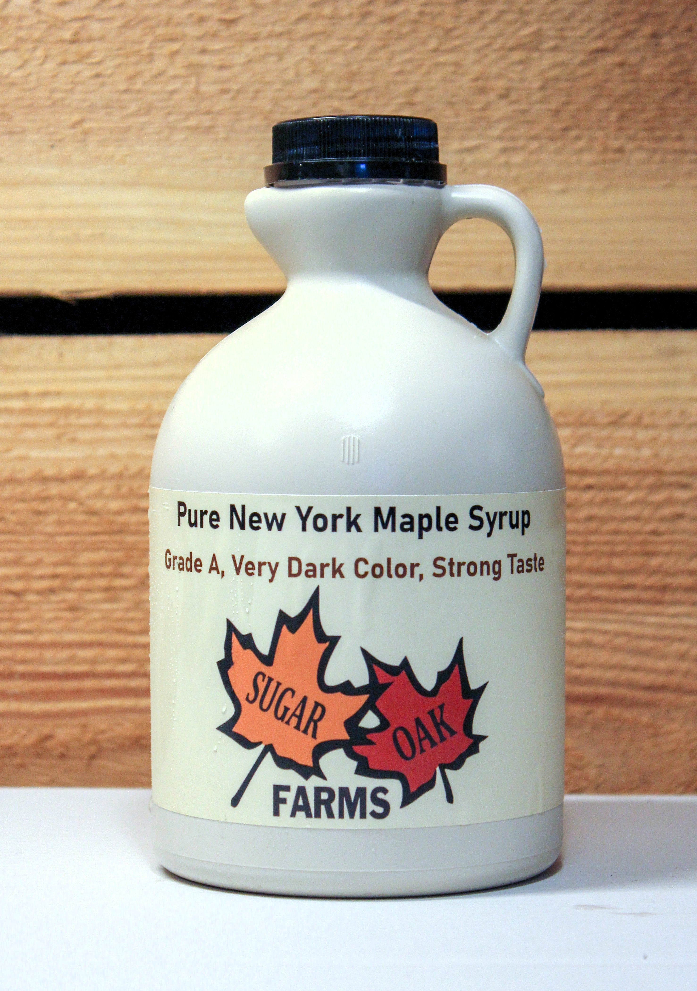 A plastic quart of very dark syrup.